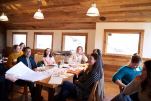 Woman raising her hand to ask a question at a Sales Force training Session 